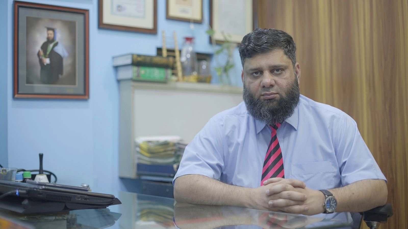 Dr. Ahmed Ejaz seated at his consultation desk